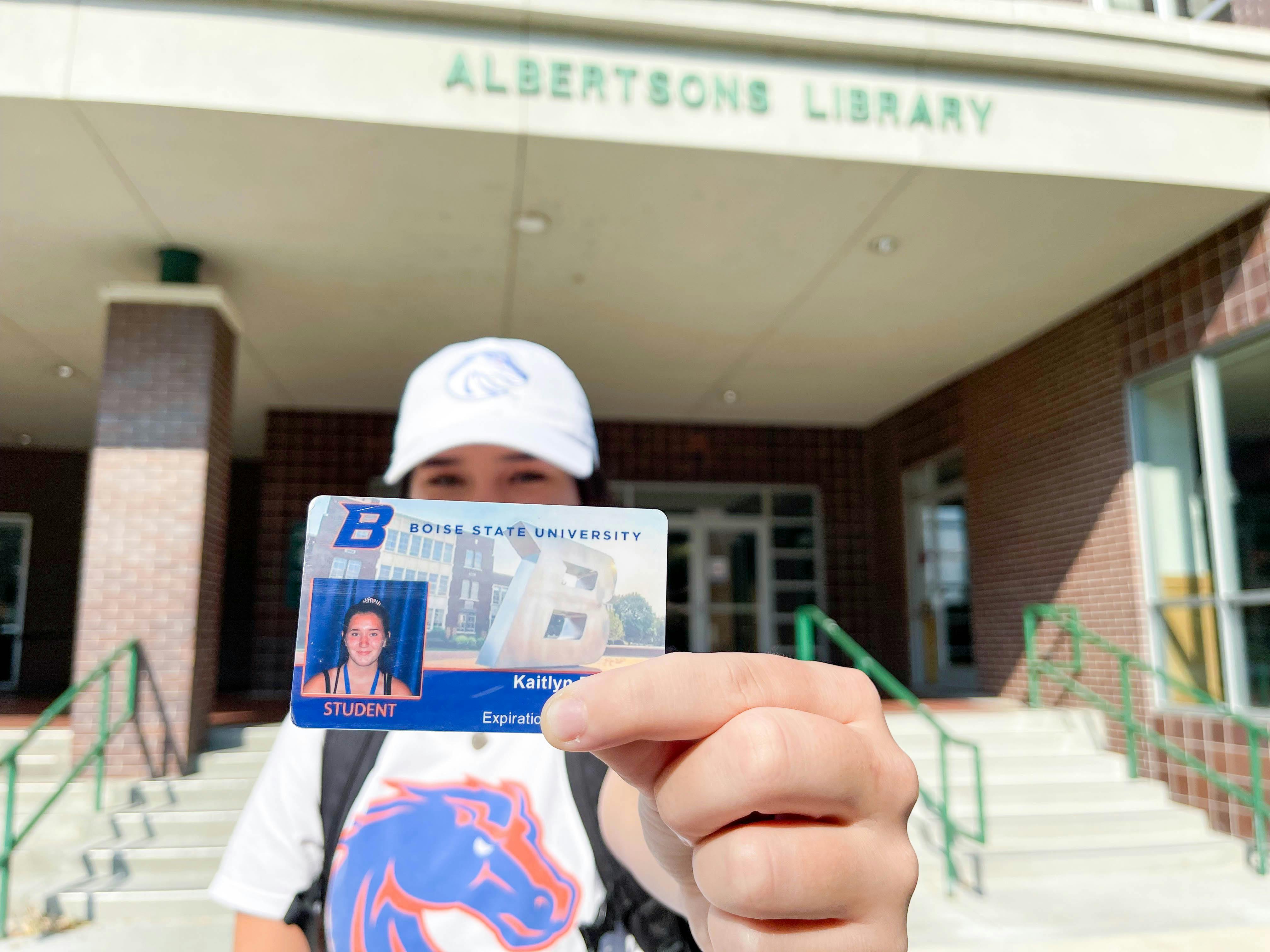 college student holding out student id