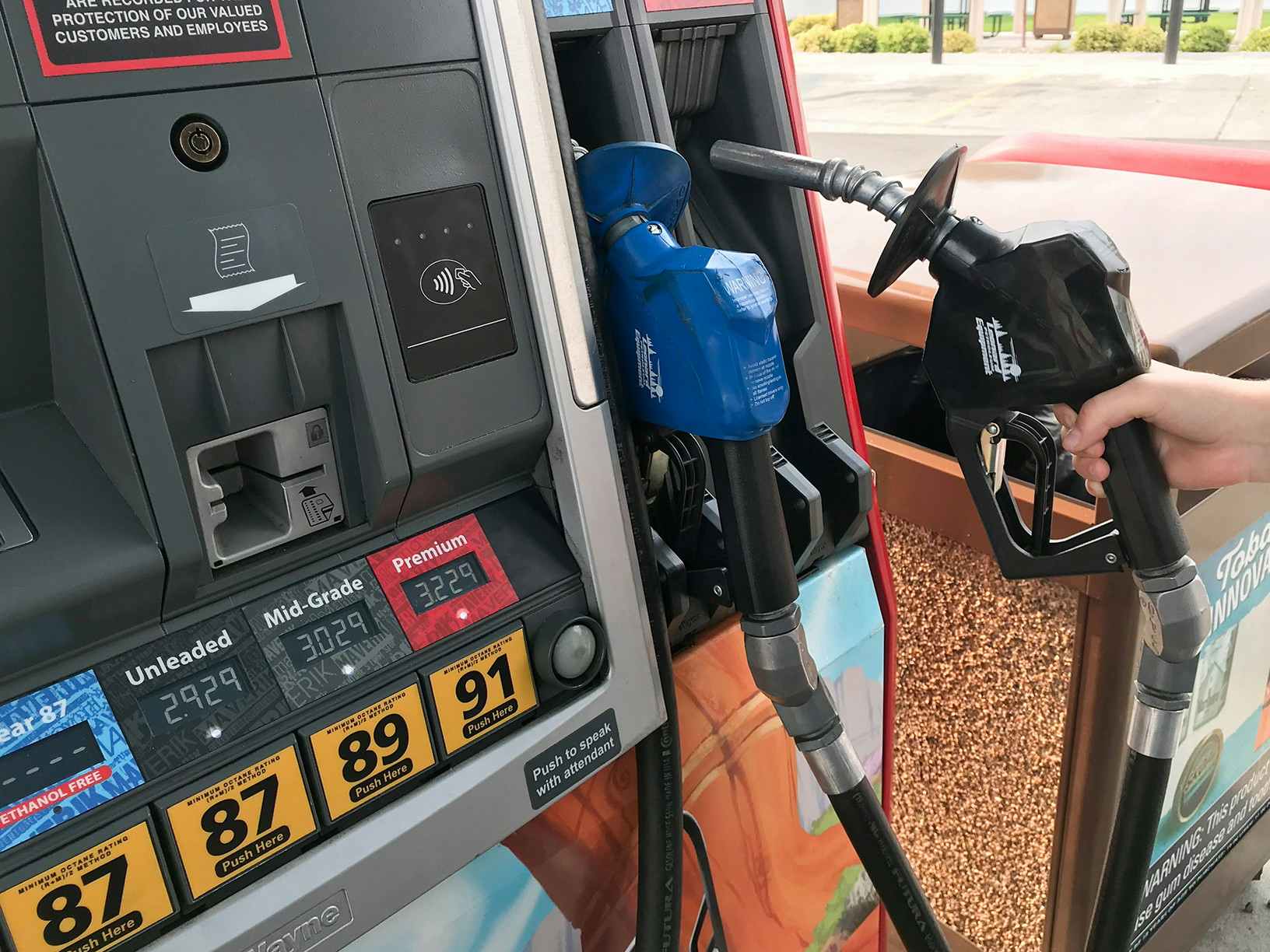 A person holding a gas pump handle.