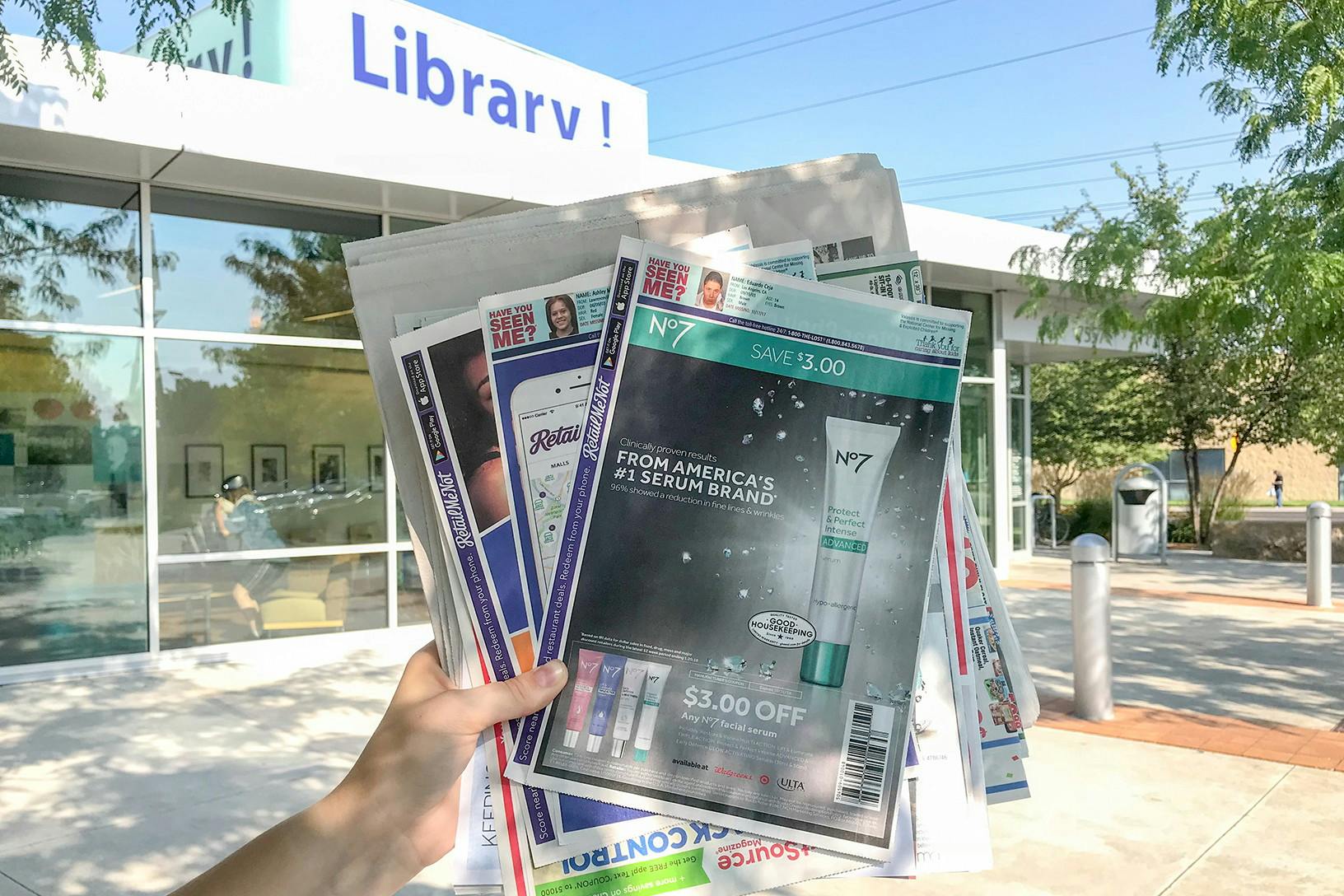someone holding papers in front of library