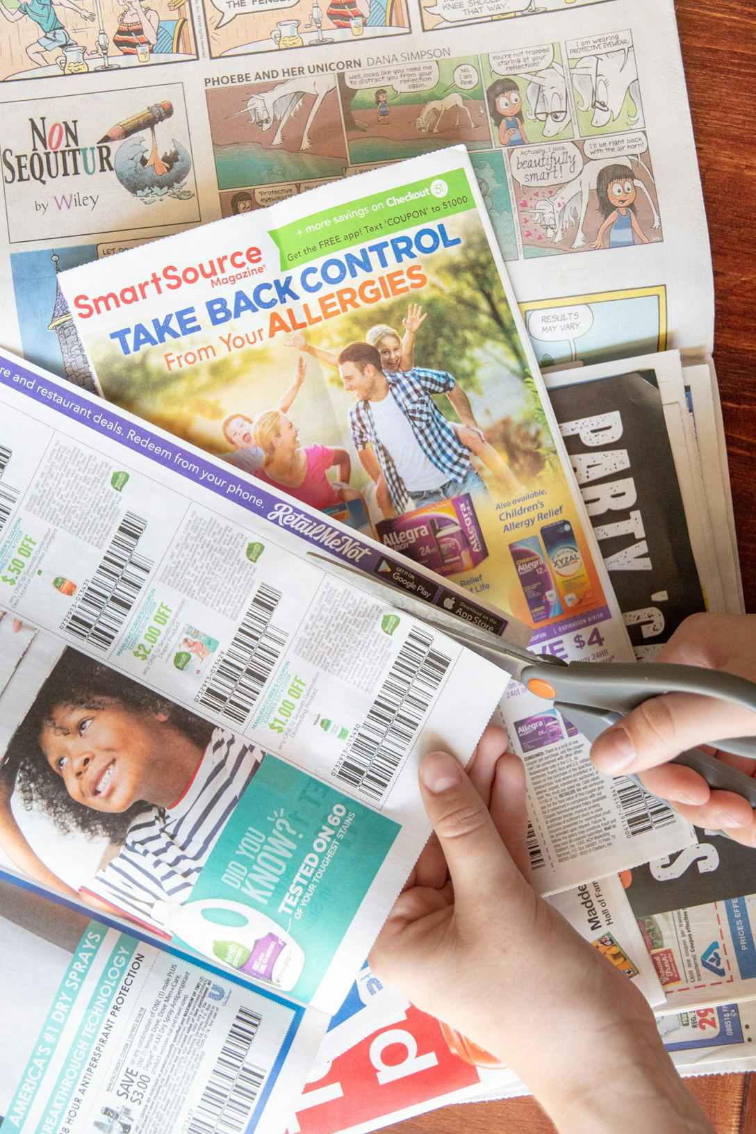 A person holding newspaper inserts.