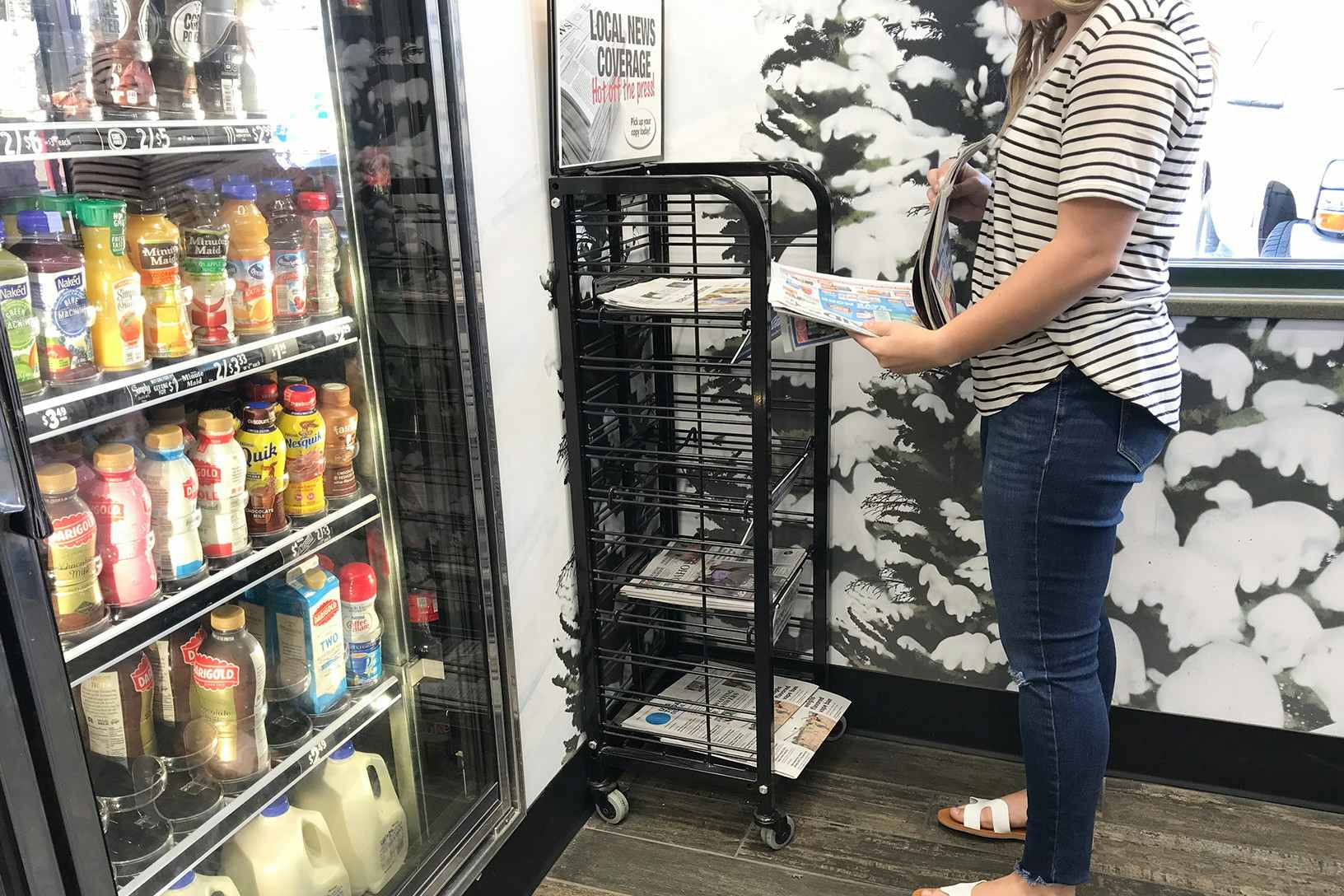 someone grabbing paper at gas station