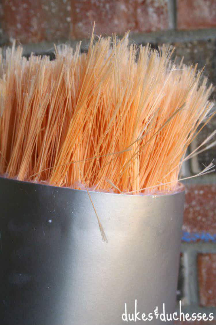 Turn broom bristles and poster board into a paintbrush.