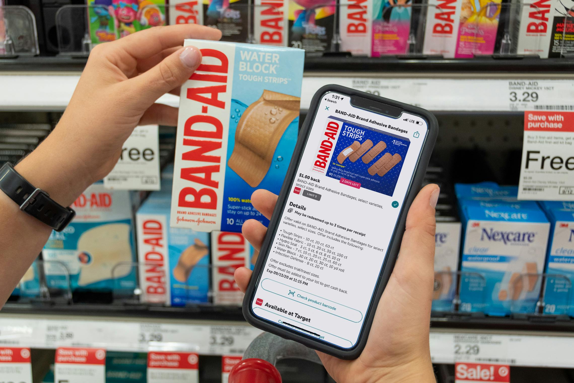 A person holding up their phone, displaying the Ibotta app with a rebate for Band-Aid, next to a a box of Band-Aids at Target