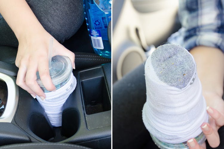 someone putting a cup with a sock on it in a cup holder