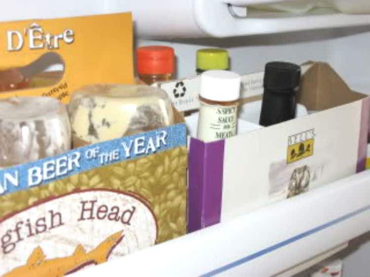 Organize door shelves with six-pack beer boxes.
