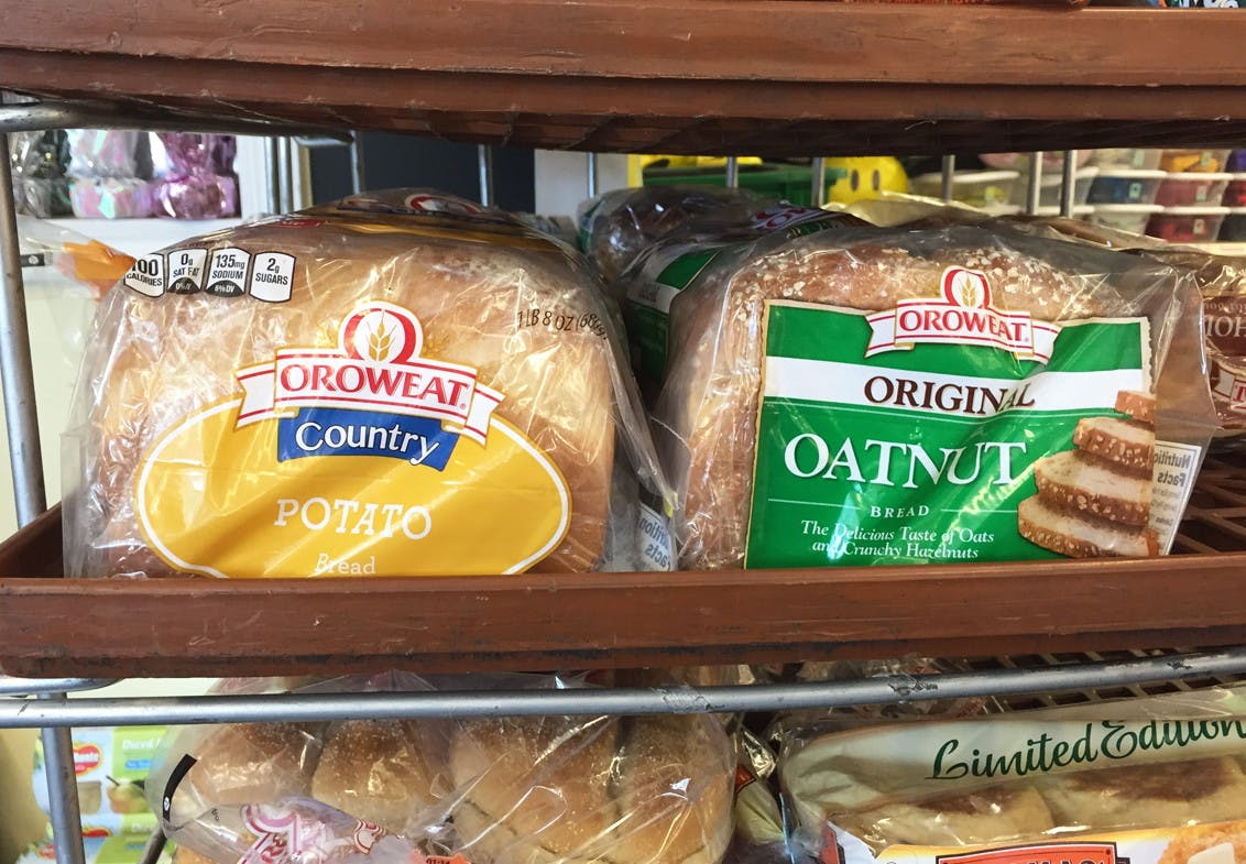 Loaves off Oroweat bread sitting on a shelf at Dollar Tree.