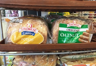 Loaves off Oroweat bread sitting on a shelf at Dollar Tree.