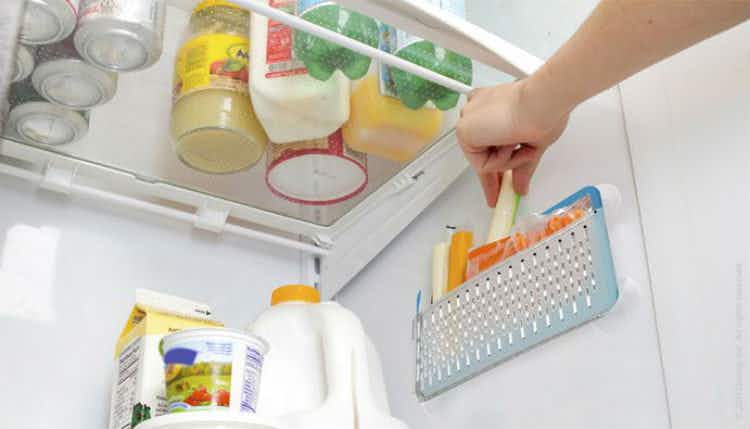 Hang suction baskets on the side of the fridge.