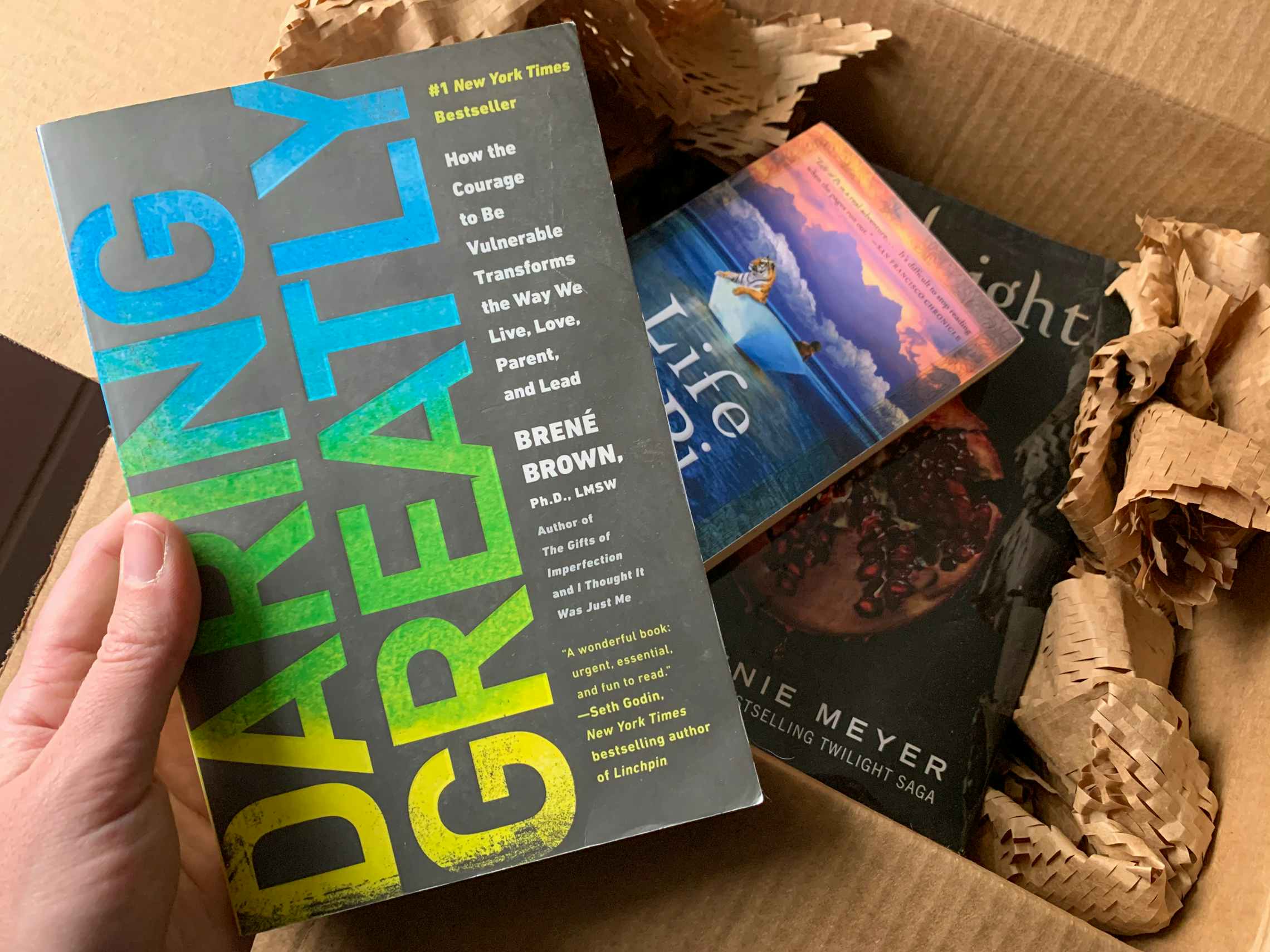Books being pulled from a shipping box.