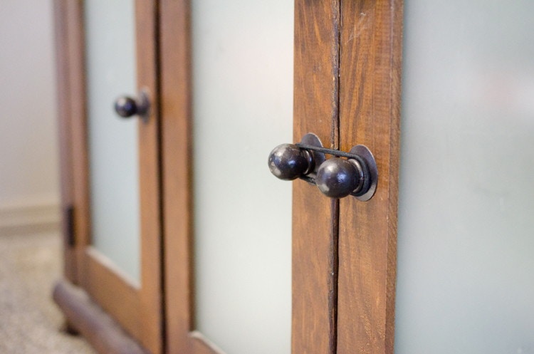 Childproof cabinet doors with hair ties.