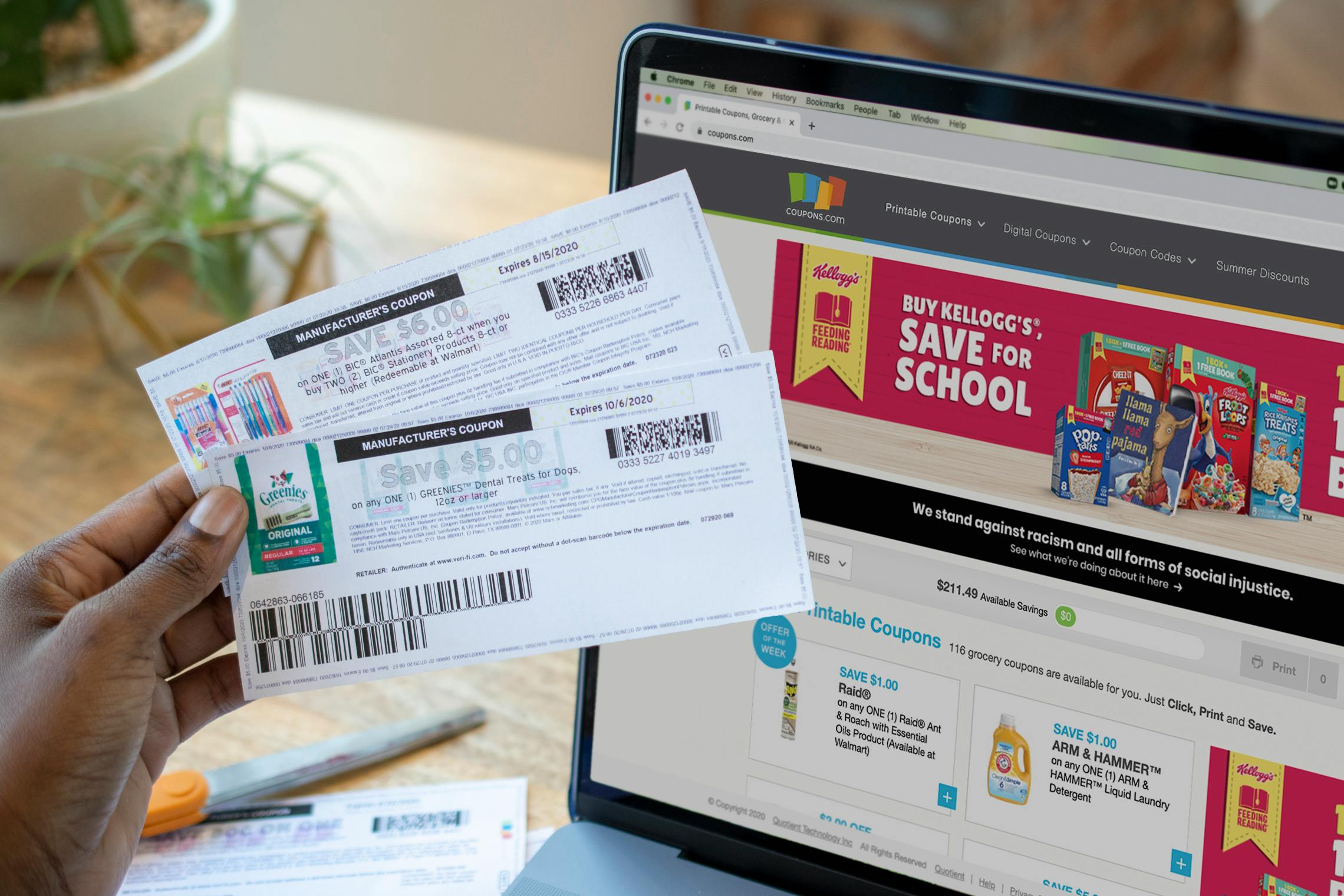 A person holding coupons next to the coupons.com website open on a computer screen.