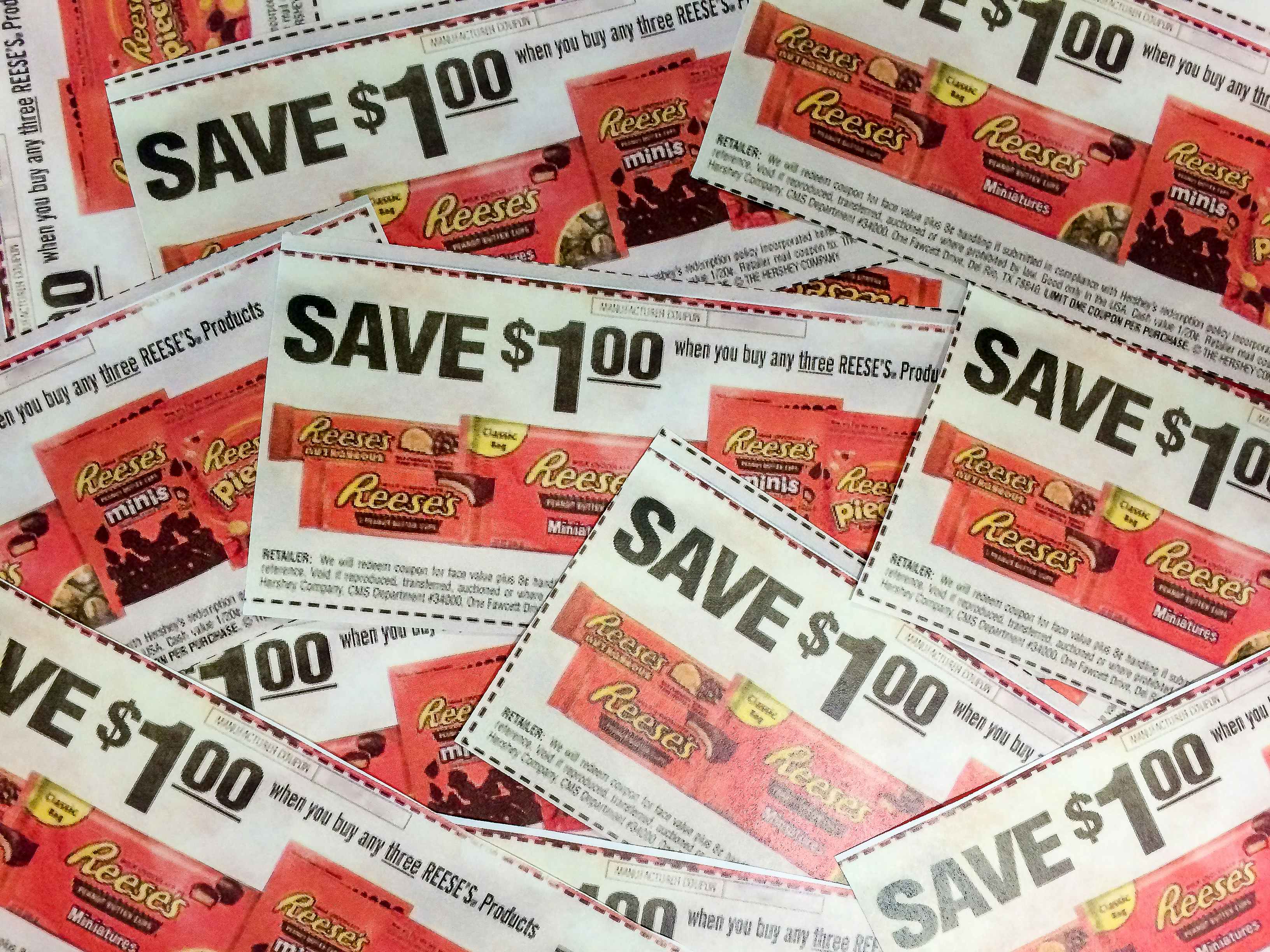 A pile of candy coupons that say, "Save $1 on any three Reese's products