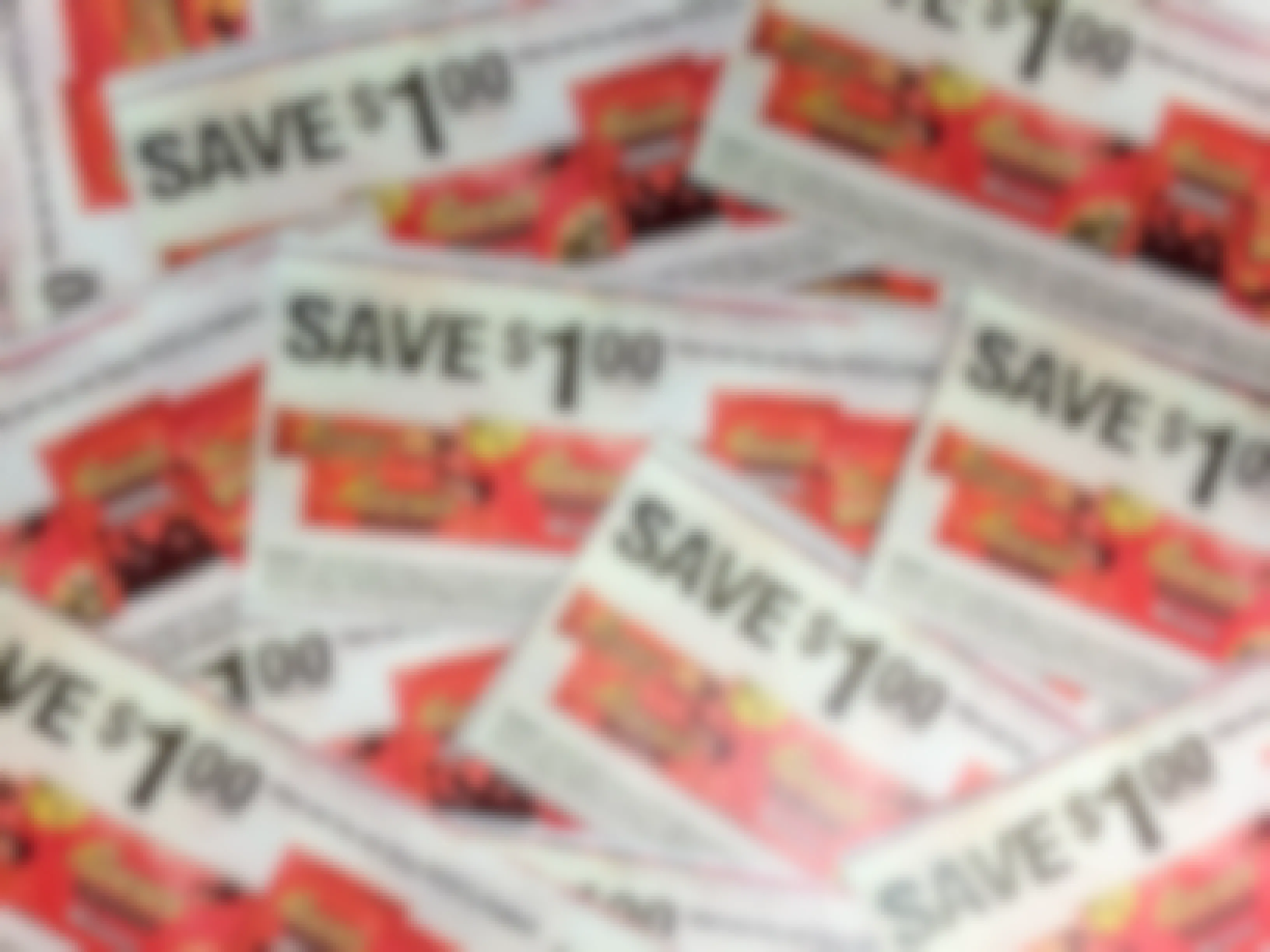 A pile of candy coupons that say, "Save $1 on any three Reese's products