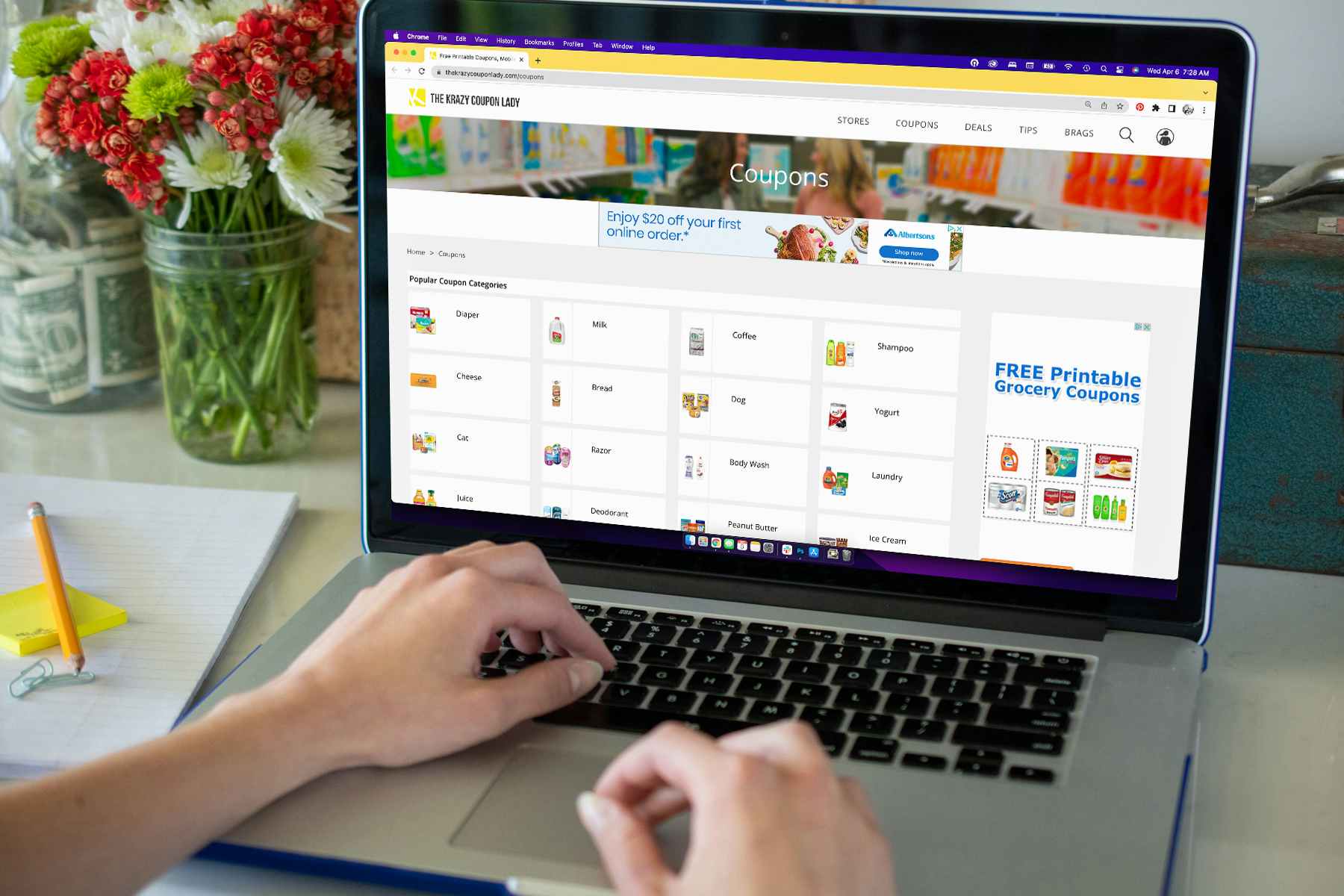 A person using a laptop computer, looking at coupons on the krazy coupon lady coupon database.