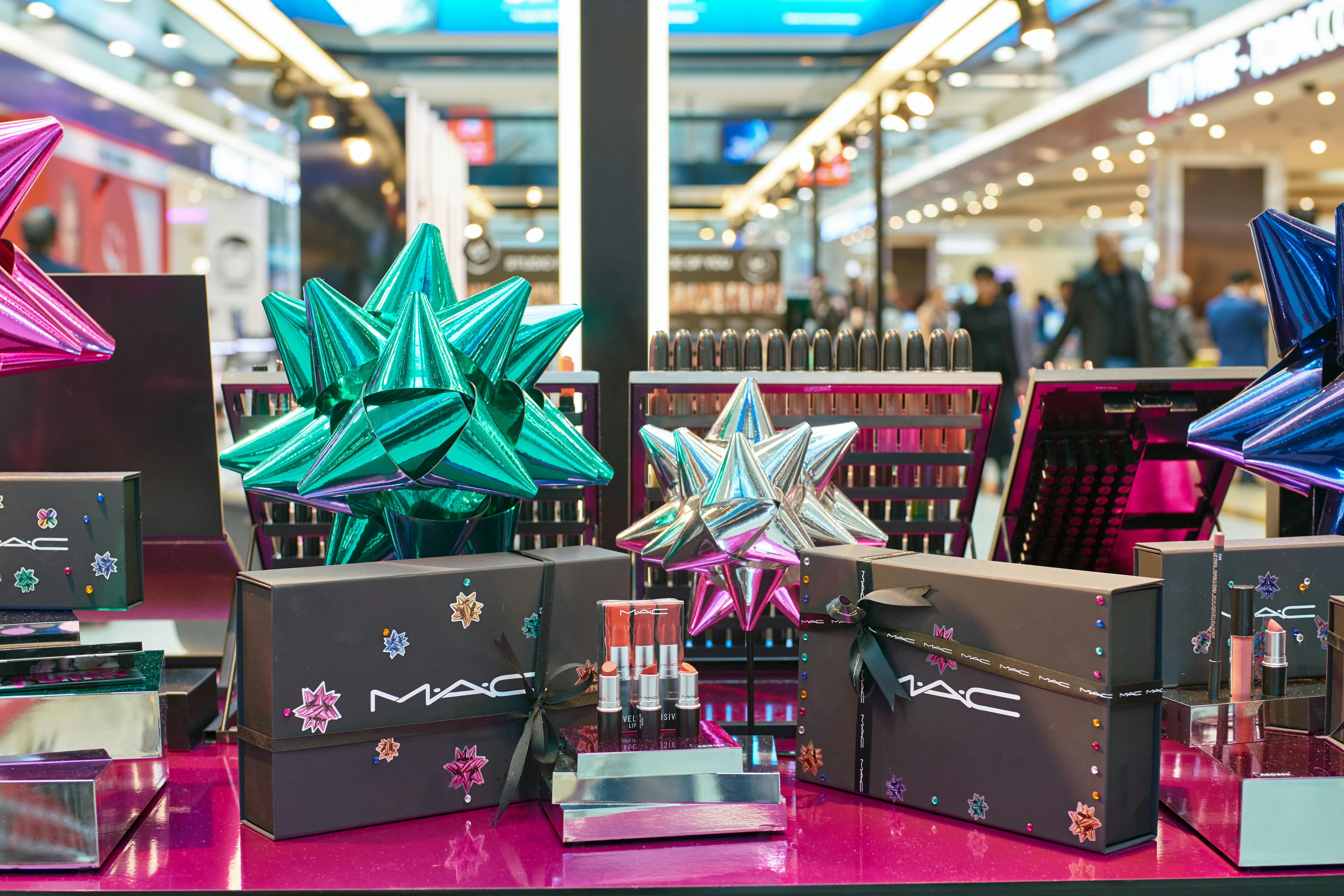 A MAC makeup counter display with lipsticks and boxes of makeup.