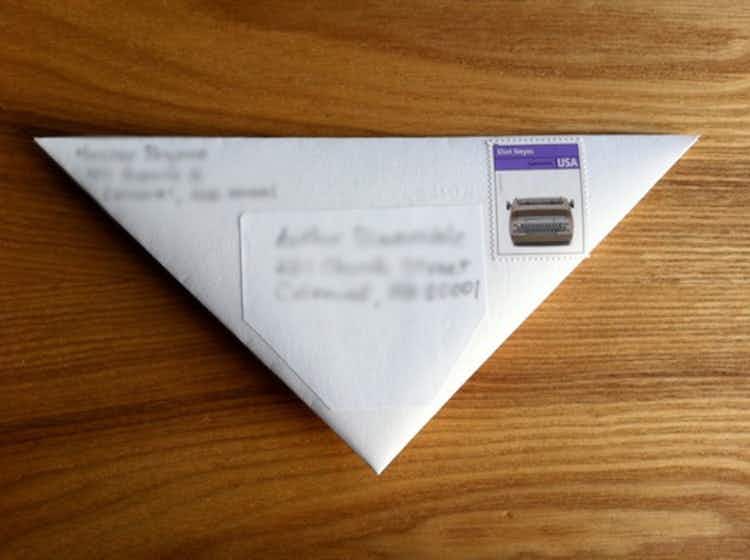 Fold an origami letter and stick a stamp on it.