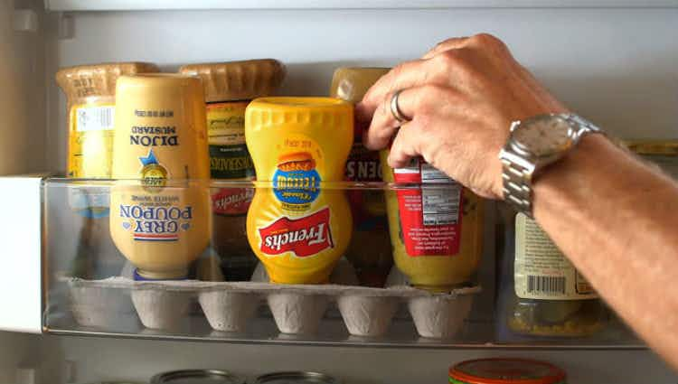 Stand upside down condiment bottles in an egg carton.