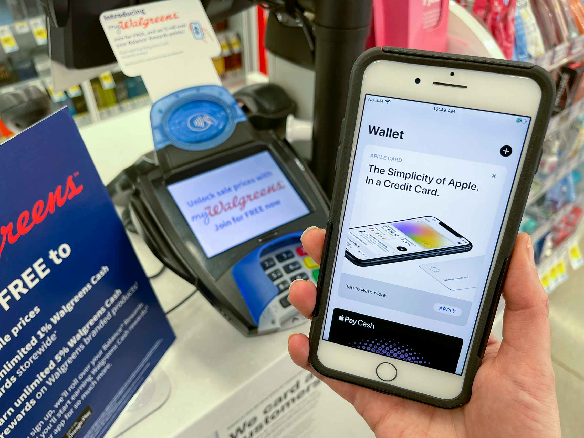A cell phone displaying the Apple credit card on a phone near the checkout at Walgreens