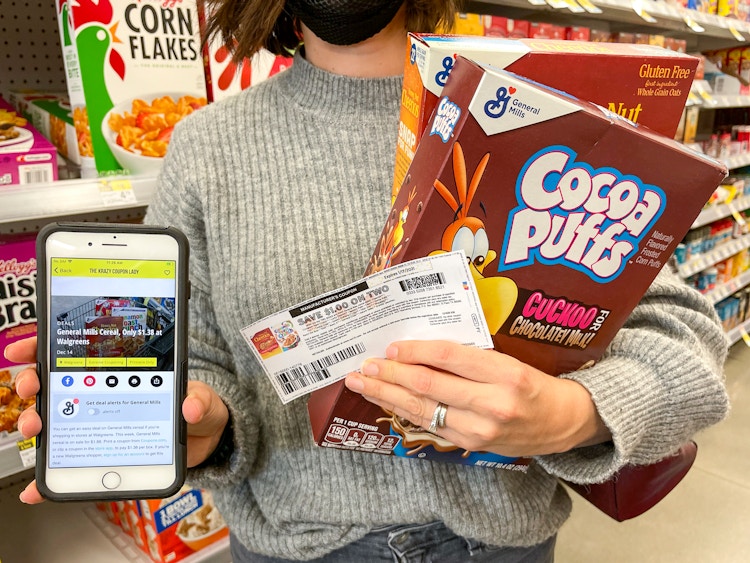 woman holding cocoa puffs, coupon and phone with kcl app