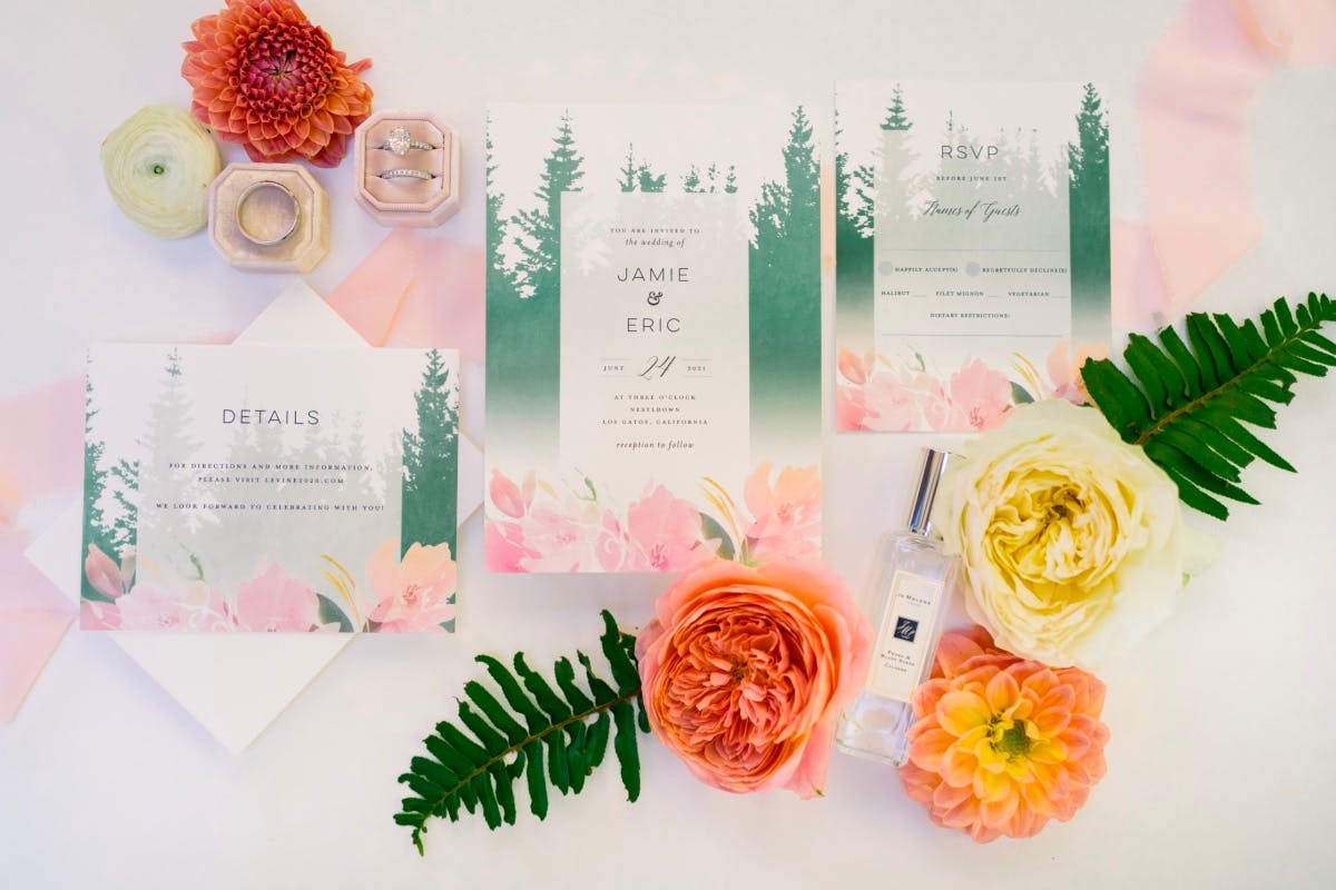 Custom wedding invitations from Wedding Chicks, laid out with some flowers.