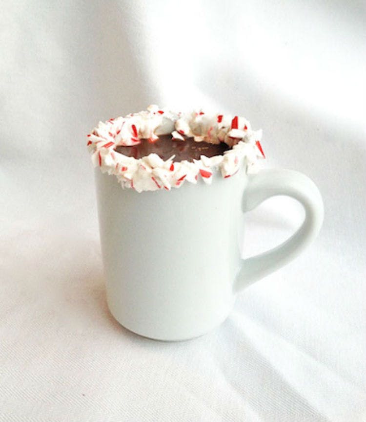 Sip hot chocolate from a mug dipped in crushed candy canes.