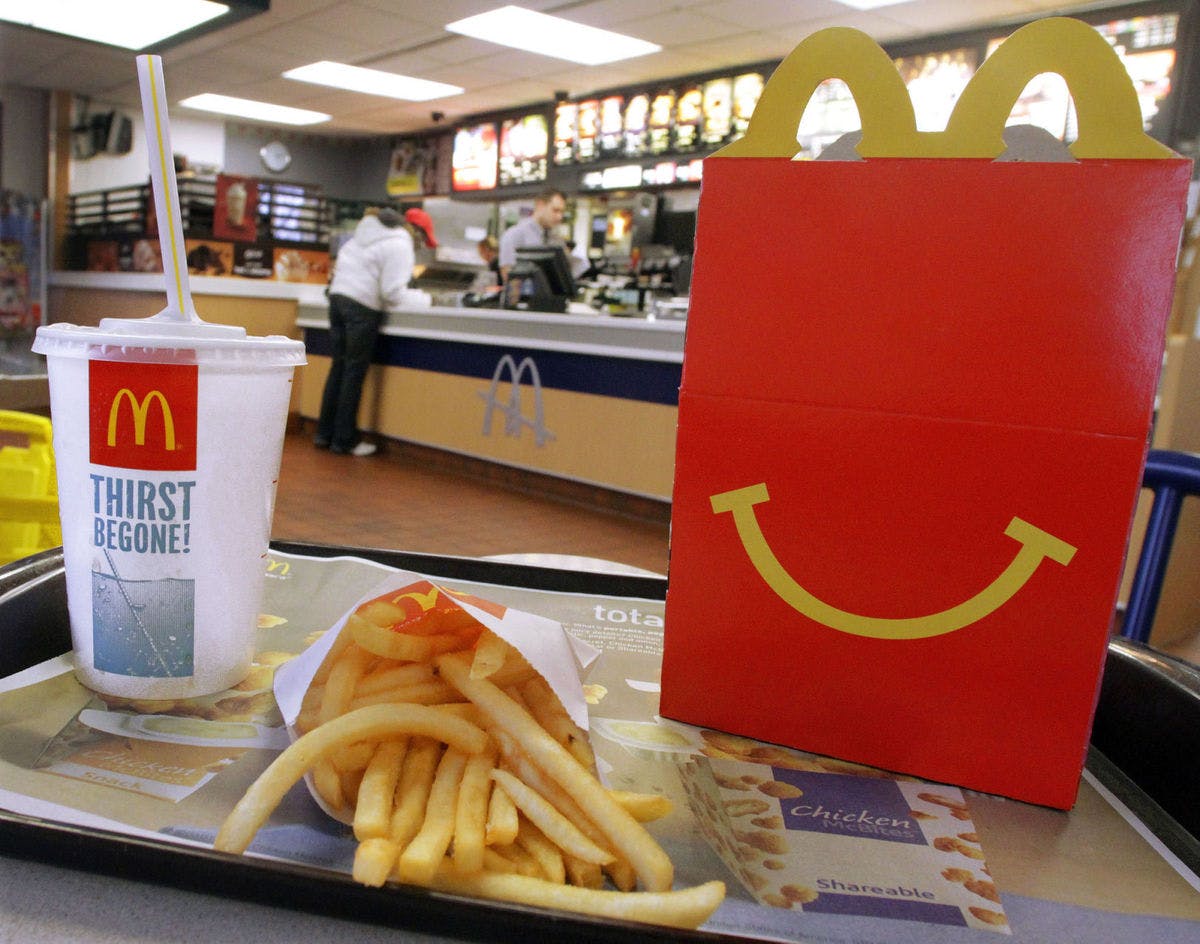 A McDonald's Happy Meal sitting on a table in the restaurant.