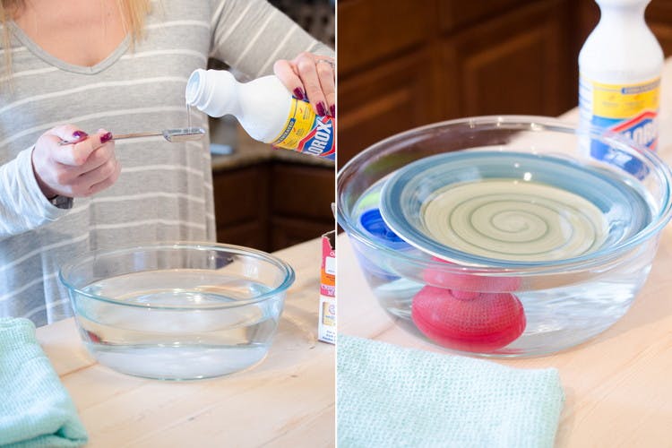 Clorox bleach being measured and poured into a glass bowl of water and water bottle lids.