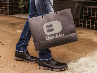 someone holding a bag from Buckle