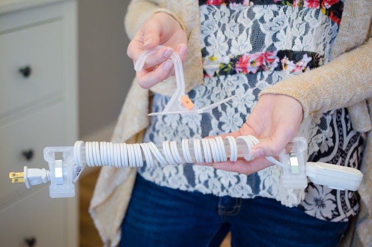 Prevent cords from unraveling with a pants hanger.