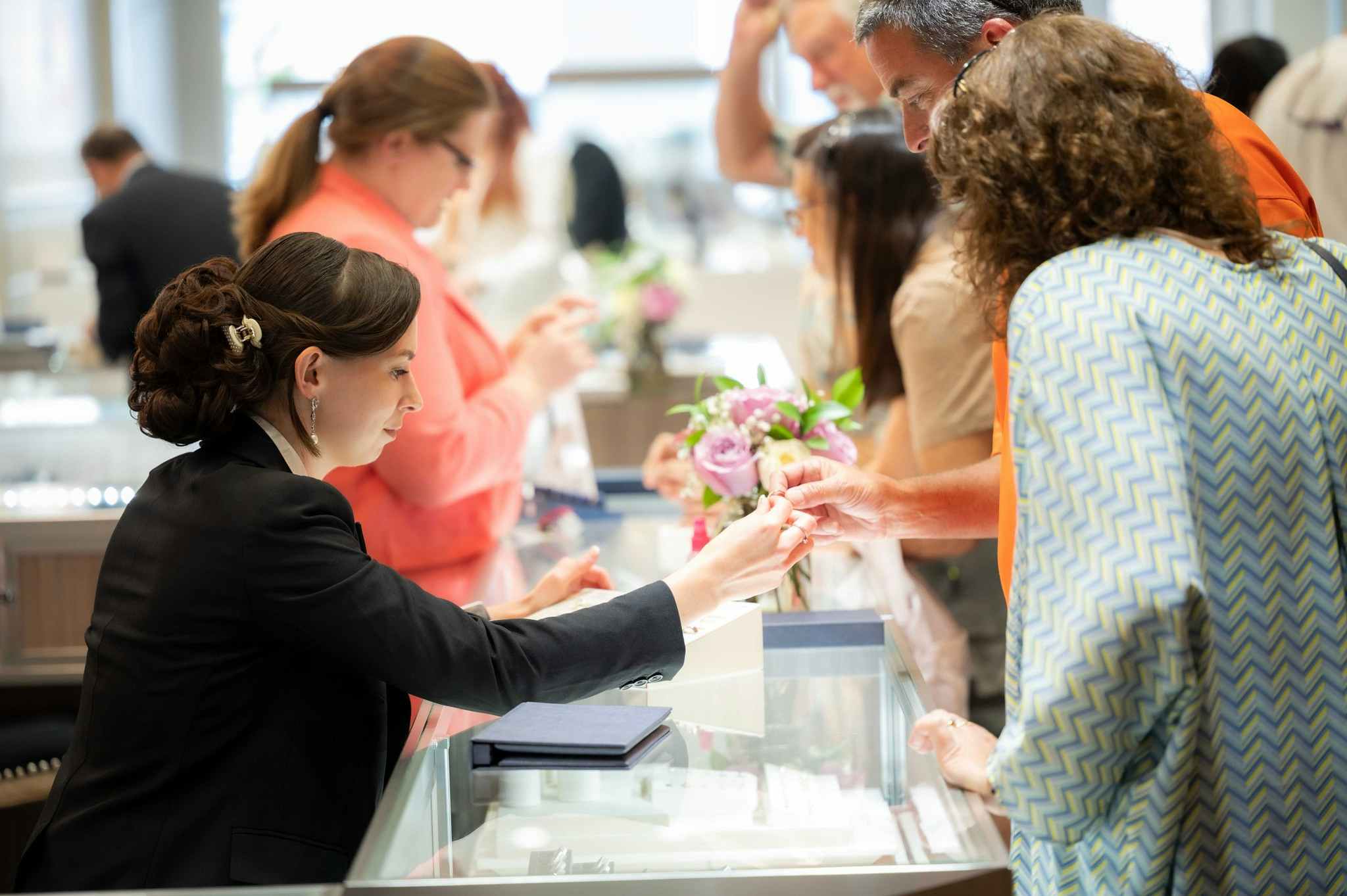 people shopping at a Day's Jewelers counter