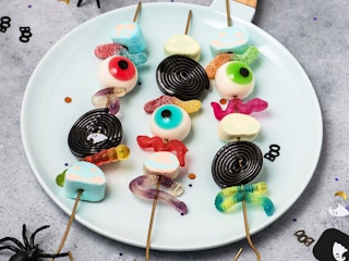 Kebobs of leftover Halloween candy on a plate.