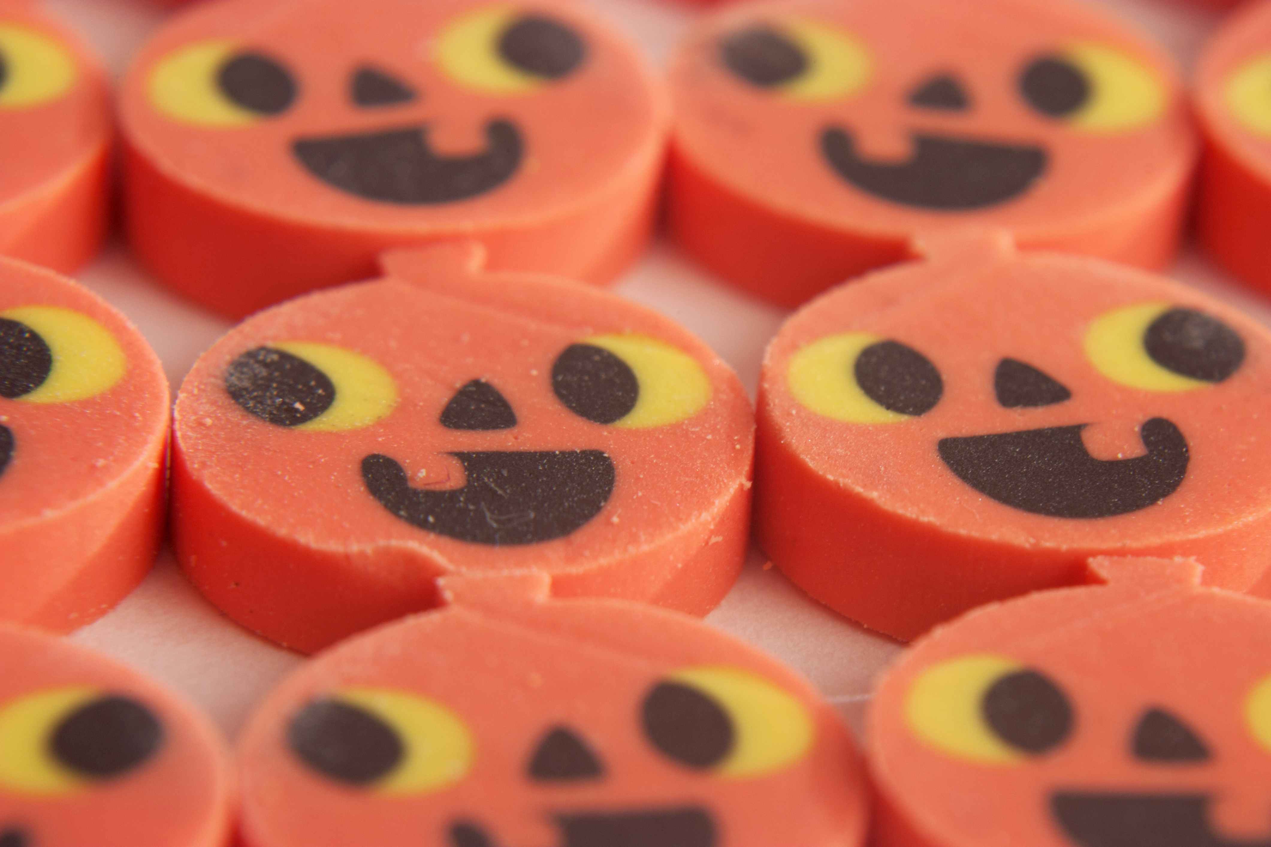 A close-up on pumpkin shaped erasers.