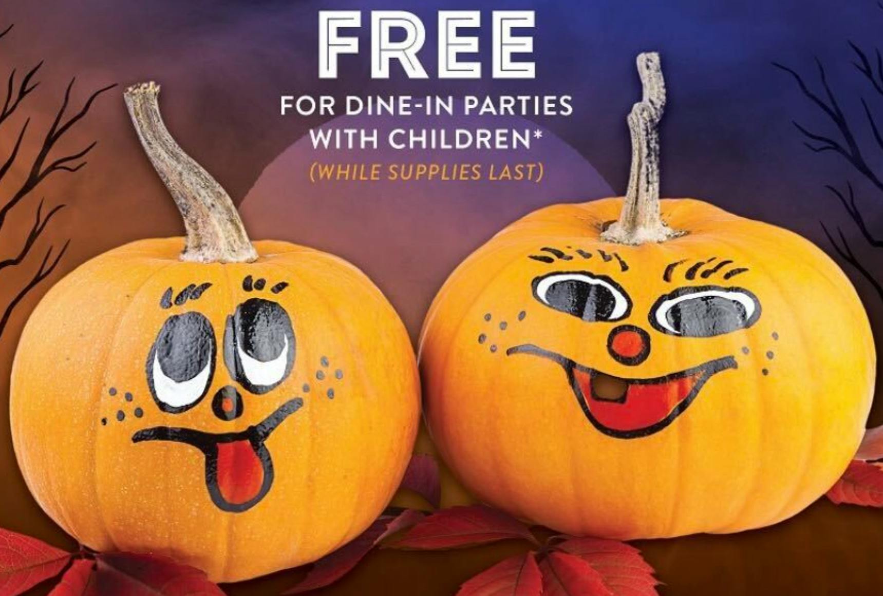 two decorated pumpkins from kona grill sitting side by side