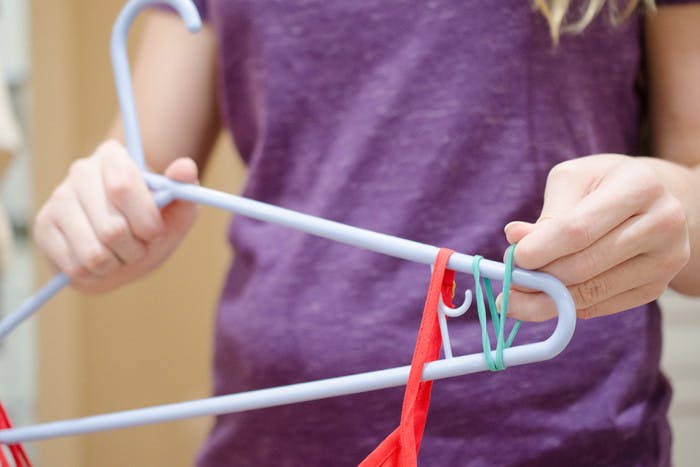 Prevent clothes from slipping off hangers with rubber bands.