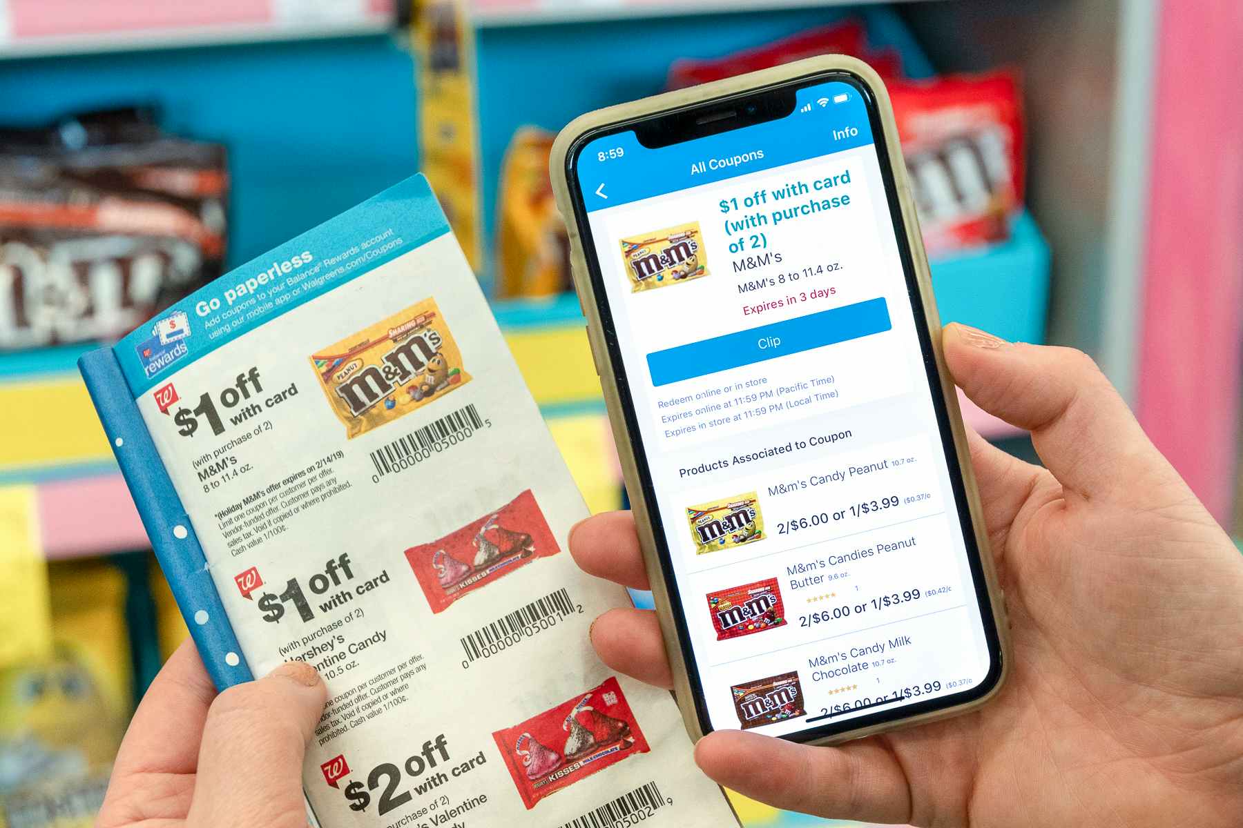 A person holding a cell phone displaying an online coupon next to a paper coupon from a Walgreens ad