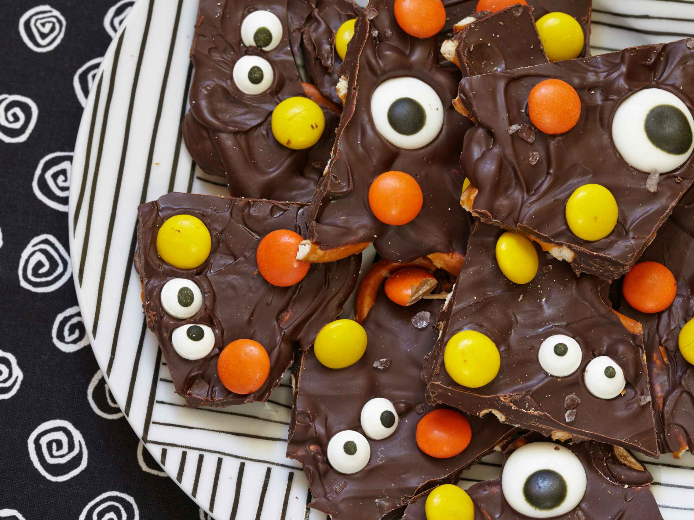 A plate of chocolate bark made with Reese's pieces.