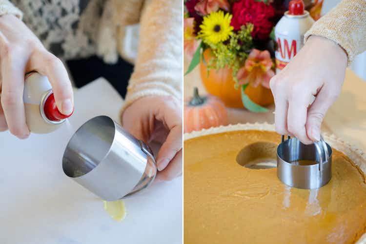 A person spraying cooking oil onto a biscuit cutter and using it to cut mini-pies out of a large pumpkin pie.