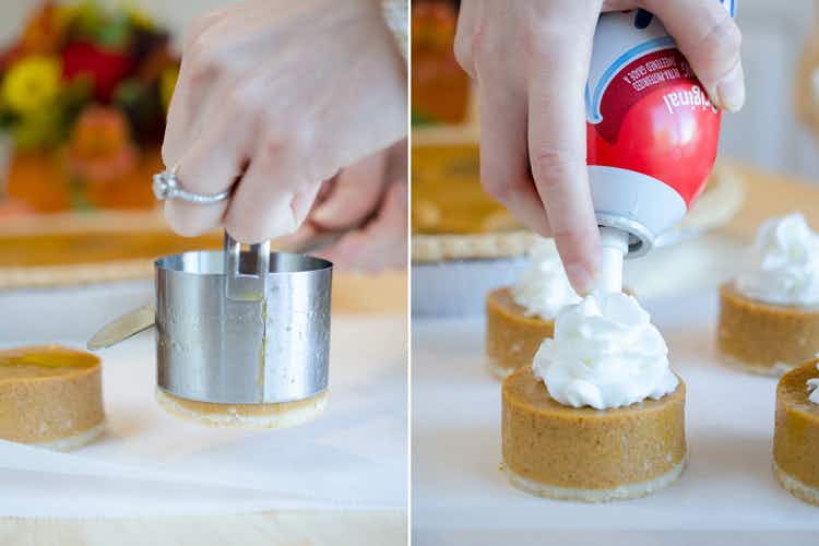 A person putting a mini pumpkin pie from a biscuit cutter onto a plate and spraying whipped cream on top of it.