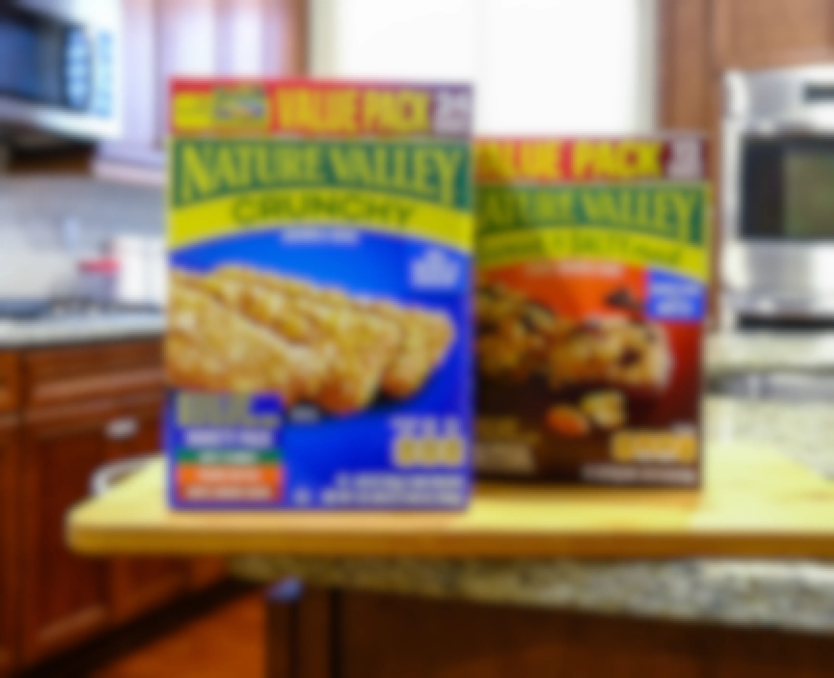 Two boxes of Nature Valley bars sitting on a kitchen counter.