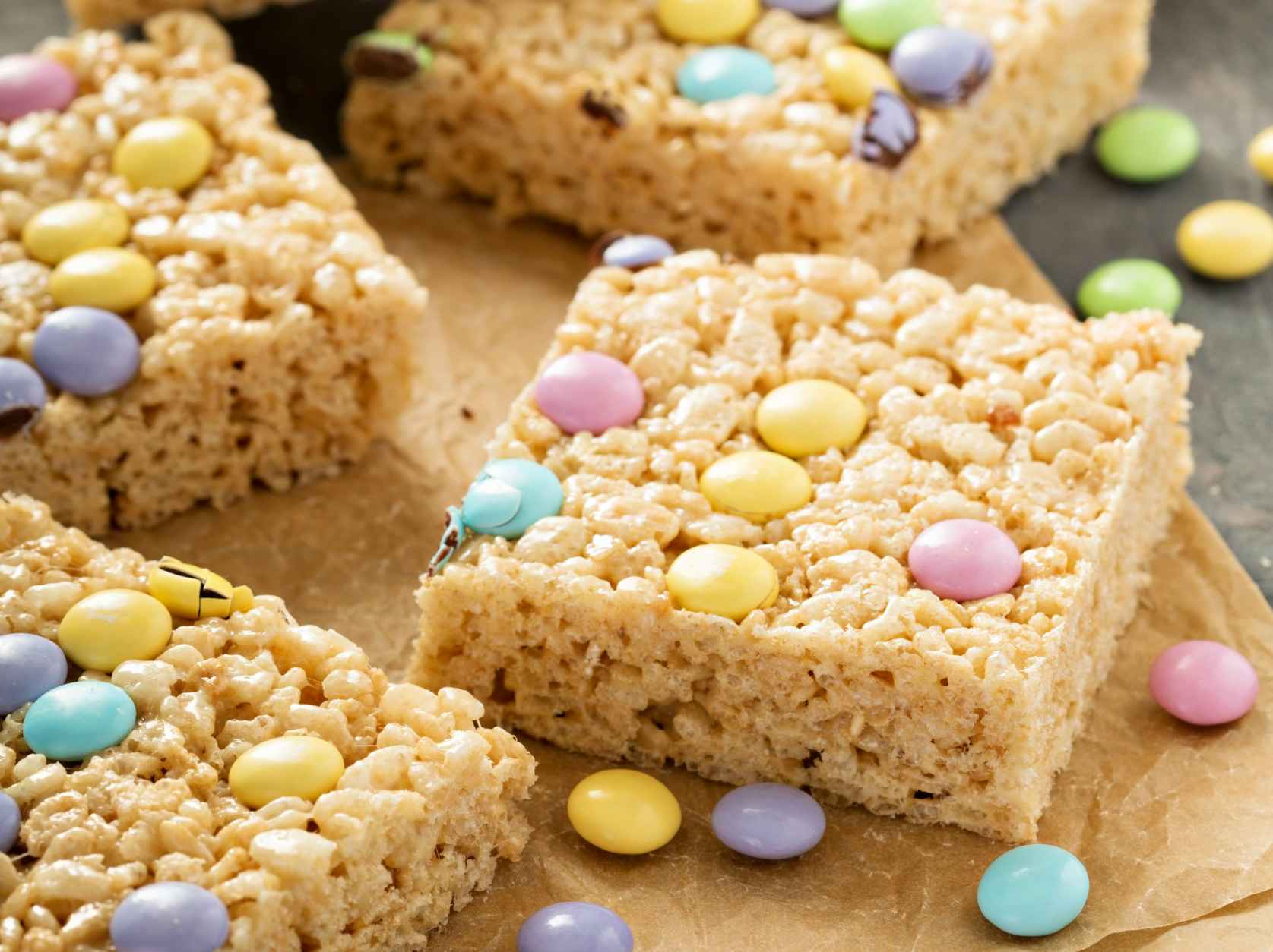 Rice krispies treats with chocolate candy on them.