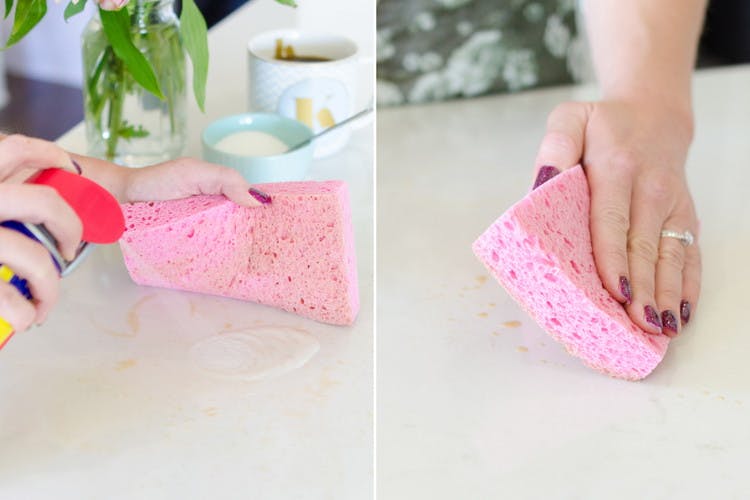 WD-40 being sprayed on a kitchen counter then someone wiping with a sponge