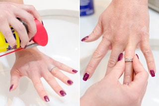 Woman spraying WD-40 directly onto a stuck ring, then trying to pull it off