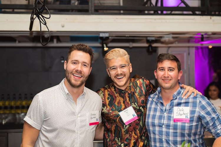 three male kaplan employees look happy