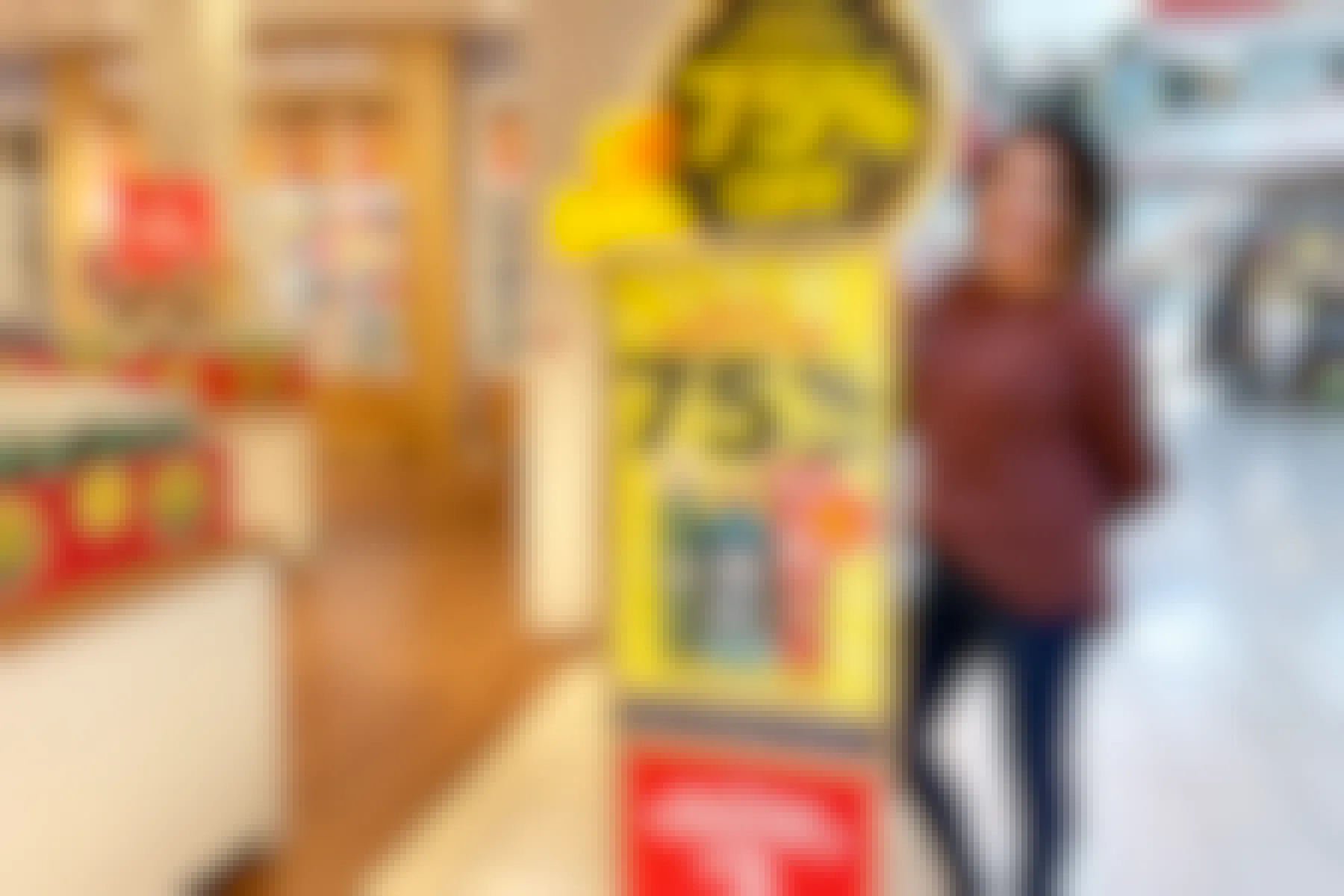 woman standing next to bath and body works clearance sign