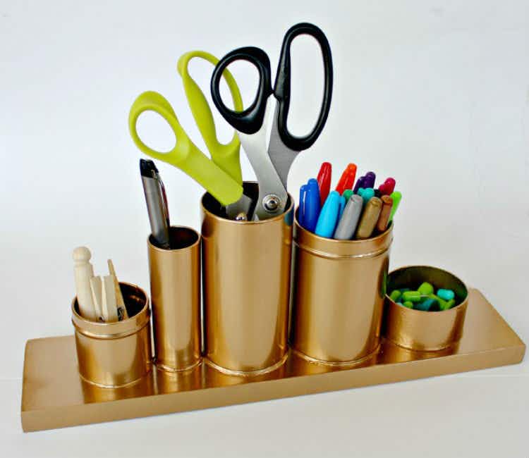 Put together a gold pencil holder with recycled containers.