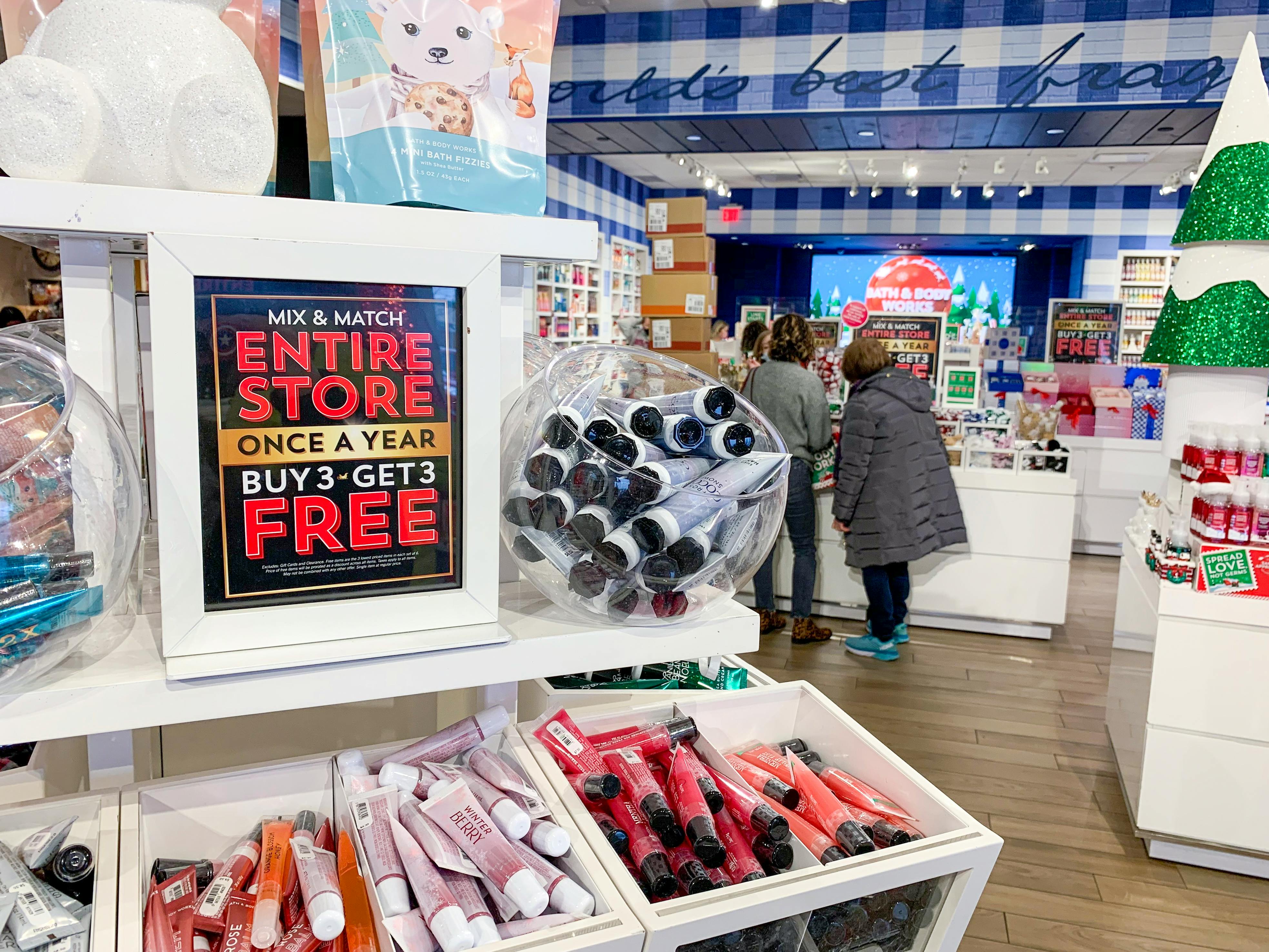 A sales sign inside a bath and body works during Black Friday