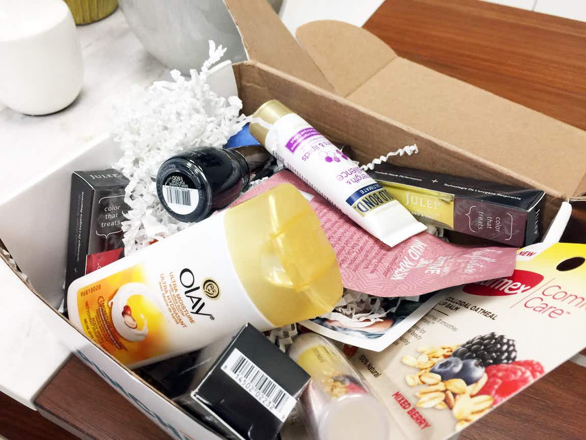 A box of beauty product samples sitting open on a table.