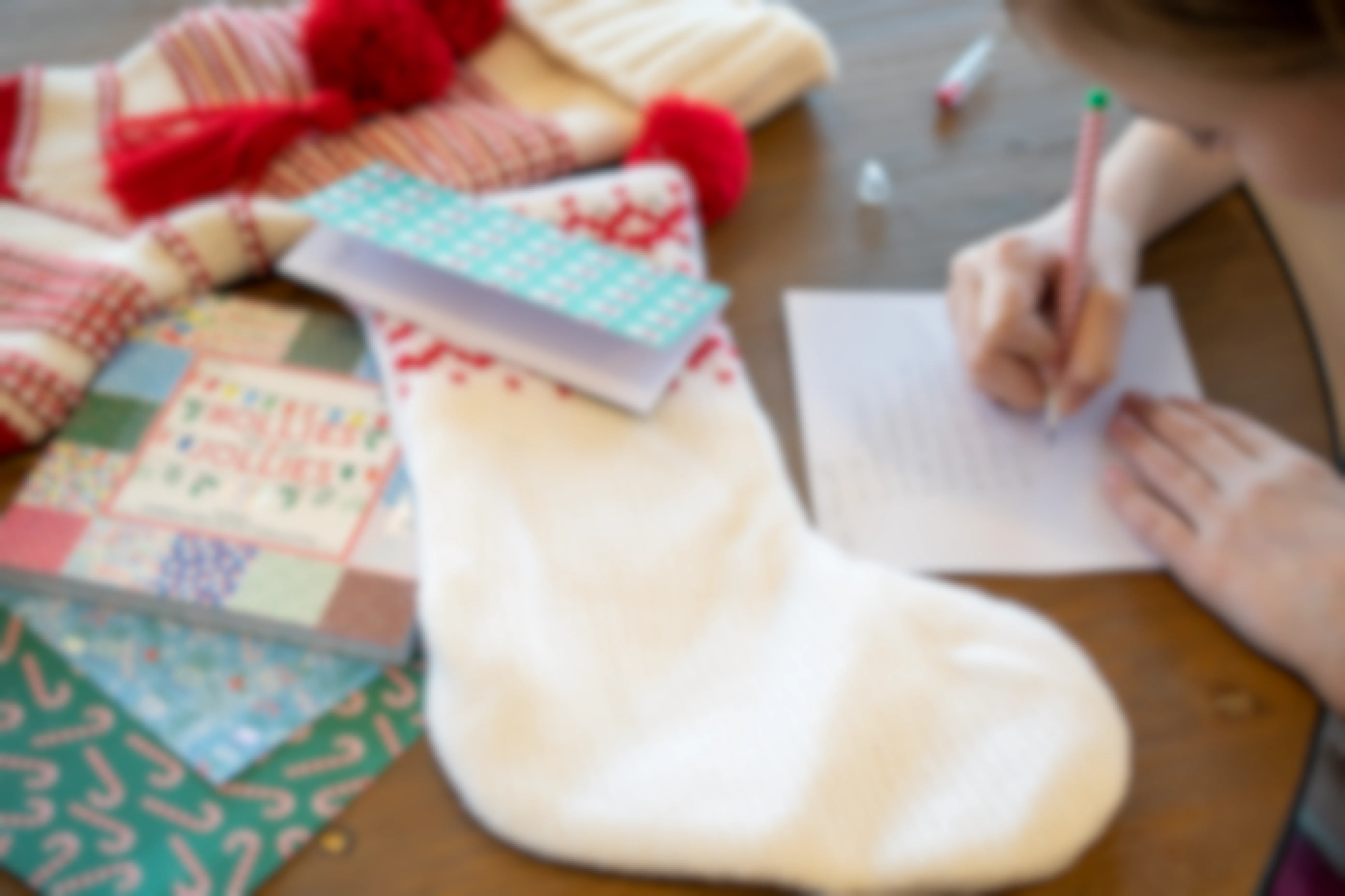 Kids writing notes on Christmas card stock and putting them in their stockings.