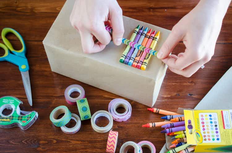 Tape crayons and toys onto kraft-paper wrapped gifts.