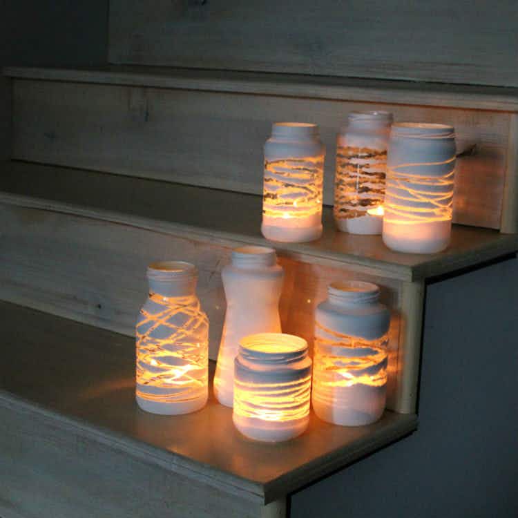 Wrap yarn around a jar and spray paint it for a stylish candle holder.